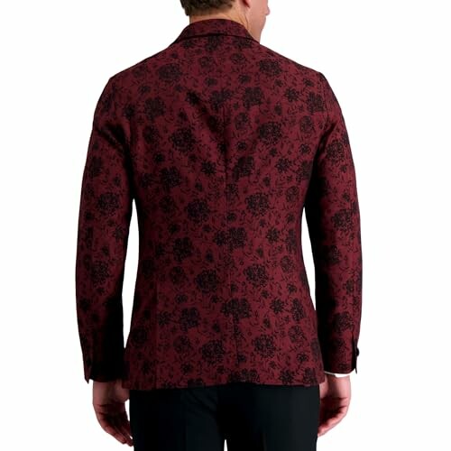 Back view of a red floral patterned blazer worn by a person.