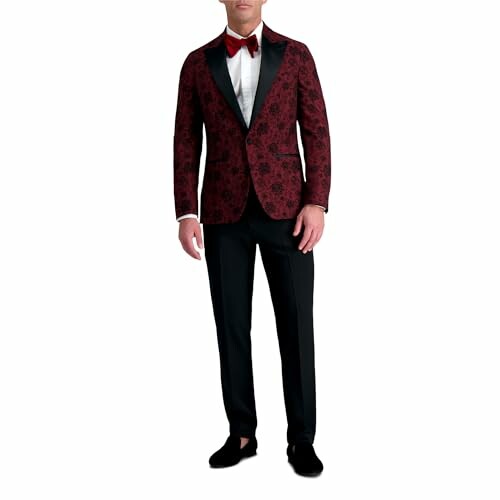 Man in red floral tuxedo with black pants and red bow tie.